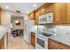 Kitchen features white appliances, granite counters, and wood cabinets at 1478 Navigator Rd, Punta Gorda, FL 33983