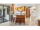 Kitchen island with granite countertop and three wooden stools at 1478 Navigator Rd, Punta Gorda, FL 33983