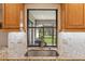 Kitchen sink with granite countertop and view of backyard through window at 1478 Navigator Rd, Punta Gorda, FL 33983