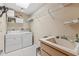 Laundry room with washer, dryer, sink and shelving at 1478 Navigator Rd, Punta Gorda, FL 33983