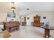 Spacious living room with piano, wooden furniture, and tile floor at 1478 Navigator Rd, Punta Gorda, FL 33983