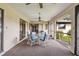 Screened porch with table and chairs, offering outdoor dining space at 1478 Navigator Rd, Punta Gorda, FL 33983