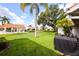 Spacious backyard with lush grass and palm trees at 4872 Limetree Ln, Venice, FL 34293