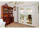 Home office features built-in wooden shelving and French doors leading to a patio at 4872 Limetree Ln, Venice, FL 34293