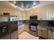 Modern kitchen with stainless steel appliances and granite countertops at 919 Sunridge Dr # 919, Sarasota, FL 34234
