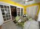 Bright sunroom with French doors and comfortable seating, overlooking the backyard at 919 Sunridge Dr # 919, Sarasota, FL 34234
