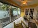 Sunroom with view of backyard, featuring French doors and relaxing seating at 919 Sunridge Dr # 919, Sarasota, FL 34234