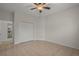 Bright bedroom featuring tile floors, a ceiling fan, and built-in shelving at 4028 Mira Lago Dr, Sarasota, FL 34238