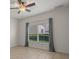 Bedroom with tile floors, ceiling fan, and window with curtains at 4028 Mira Lago Dr, Sarasota, FL 34238