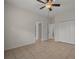 Spacious bedroom with tile flooring, ceiling fan, and ample closet space at 4028 Mira Lago Dr, Sarasota, FL 34238