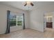 Bedroom with tile floors, ceiling fan, and access to bathroom at 4028 Mira Lago Dr, Sarasota, FL 34238