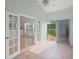 Bright sunroom with tile flooring, access to backyard, and views of lush greenery at 4028 Mira Lago Dr, Sarasota, FL 34238