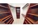 Large walk-in closet with custom built-in shelving at 4028 Mira Lago Dr, Sarasota, FL 34238