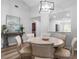 Bright dining room with a round table and six chairs, open to the kitchen at 6241 Timberlake Dr # D7, Sarasota, FL 34243