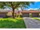 Front view of charming villa with 2-car garage and lush lawn at 6241 Timberlake Dr # D7, Sarasota, FL 34243