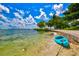 Blue kayak on a sandy beach near calm water at 6241 Timberlake Dr # D7, Sarasota, FL 34243