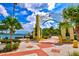 Entrance to a waterfront park with palm trees and decorative arch at 6241 Timberlake Dr # D7, Sarasota, FL 34243