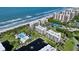 Aerial view showing resort community near the beach with tennis courts at 1095 Gulf Of Mexico Dr # 502, Longboat Key, FL 34228