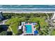 Aerial view of resort community with pool, tennis courts, and oceanfront location at 1095 Gulf Of Mexico Dr # 502, Longboat Key, FL 34228