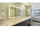 Modern bathroom with double vanity and LED mirror at 1095 Gulf Of Mexico Dr # 502, Longboat Key, FL 34228