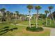 Landscaped grounds with lush lawns and palm trees at 1095 Gulf Of Mexico Dr # 502, Longboat Key, FL 34228