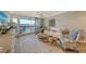 Bright living room with balcony access and coastal decor at 1095 Gulf Of Mexico Dr # 502, Longboat Key, FL 34228