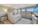 Relaxing main bedroom with water views and ceiling fan at 1095 Gulf Of Mexico Dr # 502, Longboat Key, FL 34228