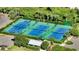 Well-maintained tennis courts in a lush, tropical setting at 1095 Gulf Of Mexico Dr # 502, Longboat Key, FL 34228