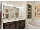 Elegant bathroom with double vanity, soaking tub, and modern fixtures at 11454 Rolling Green Dr, Bradenton, FL 34211