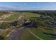 Stunning aerial view of the golf course, clubhouse, and parking area at 12240 Thornhill Ct, Lakewood Ranch, FL 34202