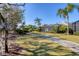 Wide view of the backyard, including the screened-in pool and sidewalk at 12240 Thornhill Ct, Lakewood Ranch, FL 34202