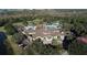 Aerial view of the community clubhouse with multiple pools, tennis courts, and parking at 12240 Thornhill Ct, Lakewood Ranch, FL 34202