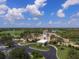 Aerial view of the luxurious clubhouse with beautiful landscaping and a golf course backdrop at 12240 Thornhill Ct, Lakewood Ranch, FL 34202