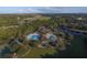 Aerial view showcasing the clubhouse amenities, including pools, tennis courts, and lush landscaping at 12240 Thornhill Ct, Lakewood Ranch, FL 34202