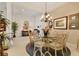 Elegant dining room with a chandelier, round table, and decorative accents at 12240 Thornhill Ct, Lakewood Ranch, FL 34202