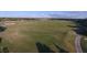 Aerial view of the driving range, set among lush trees at 12240 Thornhill Ct, Lakewood Ranch, FL 34202