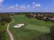 Aerial view of a beautifully maintained golf course featuring sand traps, and well-manicured greens at 12240 Thornhill Ct, Lakewood Ranch, FL 34202