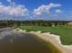 Picturesque golf course with sand traps and a scenic lake, perfect for leisure and recreation at 12240 Thornhill Ct, Lakewood Ranch, FL 34202