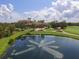 Scenic view of the golf course featuring a pond with a fountain at 12240 Thornhill Ct, Lakewood Ranch, FL 34202