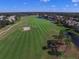 Scenic aerial view of the lush green golf course with a sand trap surrounded by water and beautiful homes at 12240 Thornhill Ct, Lakewood Ranch, FL 34202