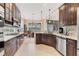 Modern kitchen showcasing dark wood cabinets, stainless appliances, and granite countertops at 12240 Thornhill Ct, Lakewood Ranch, FL 34202