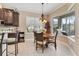 Bright breakfast nook features a round table and a view of the outdoor grill at 12240 Thornhill Ct, Lakewood Ranch, FL 34202