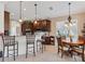 Well-lit kitchen area with bar seating and breakfast nook by the window at 12240 Thornhill Ct, Lakewood Ranch, FL 34202