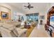 Bright living room featuring tile floors, ceiling fan, and comfortable seating at 12240 Thornhill Ct, Lakewood Ranch, FL 34202