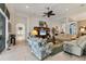 Bright living room featuring tile floors, columns, comfortable sofas, and a ceiling fan at 12240 Thornhill Ct, Lakewood Ranch, FL 34202