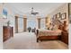 Spacious main bedroom featuring carpeted floors, ceiling fan, and a large bay window at 12240 Thornhill Ct, Lakewood Ranch, FL 34202