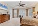 Bright main bedroom featuring carpeted floors, ceiling fan, and a large bay window at 12240 Thornhill Ct, Lakewood Ranch, FL 34202