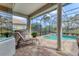 Outdoor kitchen and lounging area with a covered patio overlooking the pool at 12240 Thornhill Ct, Lakewood Ranch, FL 34202