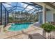 Secluded backyard features a screened-in pool, an expansive patio, and manicured greenery for ultimate relaxation and privacy at 12240 Thornhill Ct, Lakewood Ranch, FL 34202