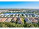 Aerial view of houses surrounding a lake in a residential community at 12640 Coastal Breeze Way, Bradenton, FL 34211